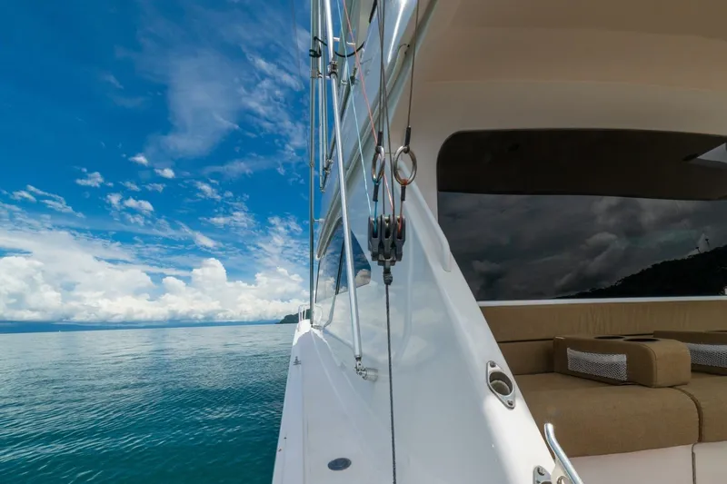 Mariah Jean Yacht Photos Pics 2004 Viking 61c yacht cruising on calm ocean under a vibrant blue sky.