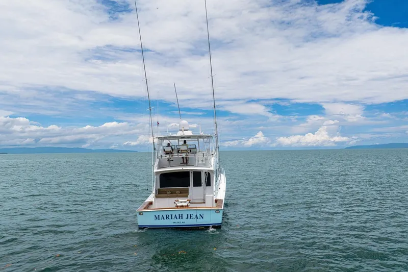 Mariah Jean Yacht Photos Pics 2004 Viking 61c boat "Mariah Jean" on open sea under blue sky.