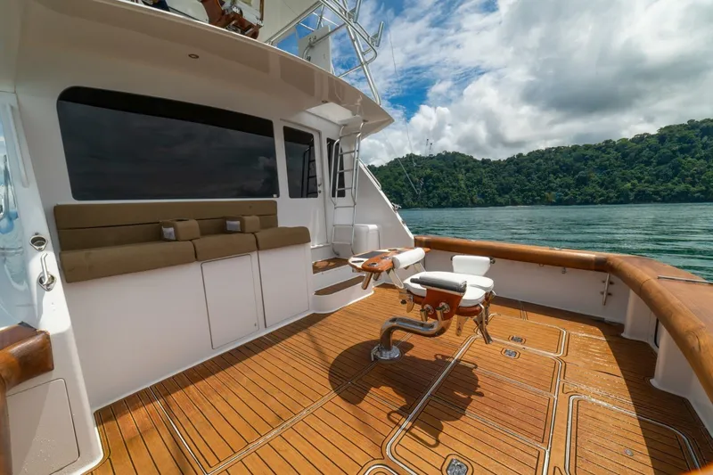 Mariah Jean Yacht Photos Pics Luxurious 2004 Viking 61c yacht deck with seating, overlooking serene waters and lush greenery.