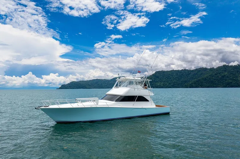 Mariah Jean Yacht Photos Pics 2004 Viking 61c yacht on calm waters with scenic mountain backdrop.