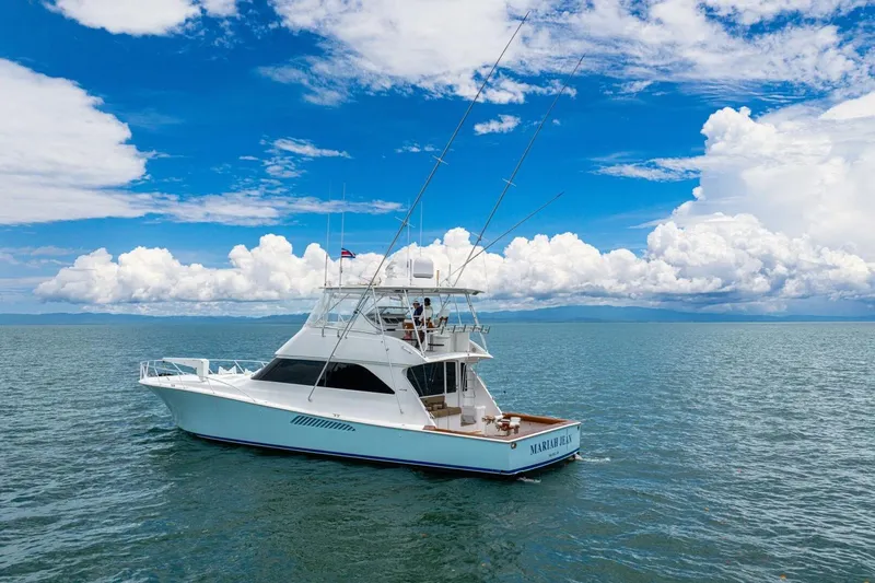 Mariah Jean Yacht Photos Pics 2004 Viking 61c yacht on open sea under blue sky and clouds.