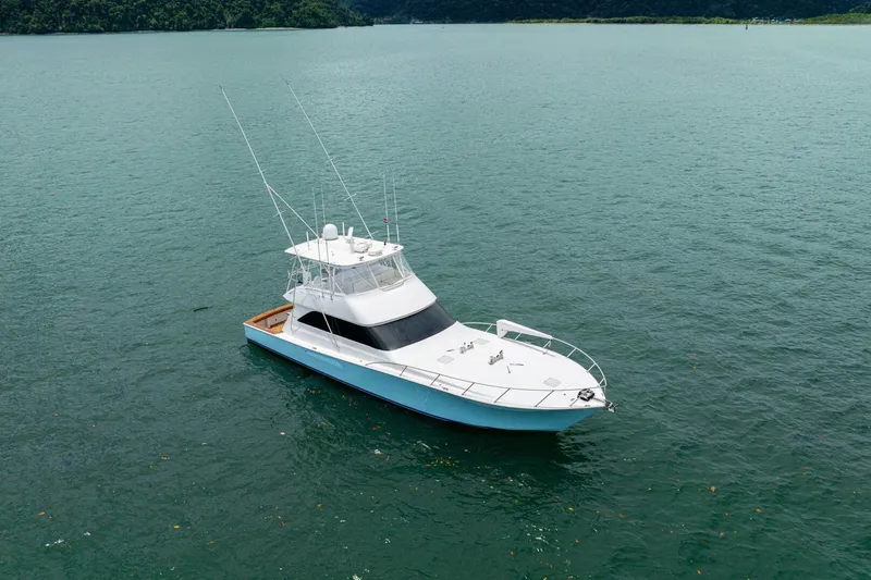 Mariah Jean Yacht Photos Pics 2004 Viking 61c yacht on calm waters, surrounded by lush green landscape.