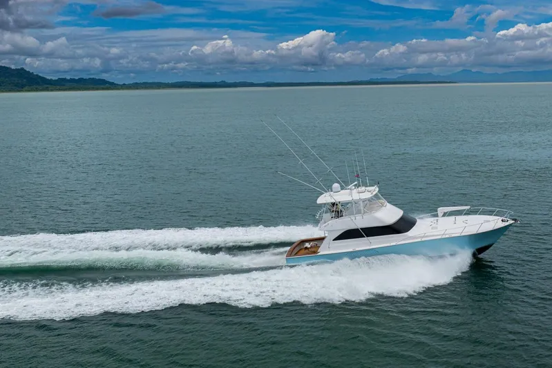 Mariah Jean Yacht Photos Pics 2004 Viking 61c yacht cruising on open water under a cloudy sky.