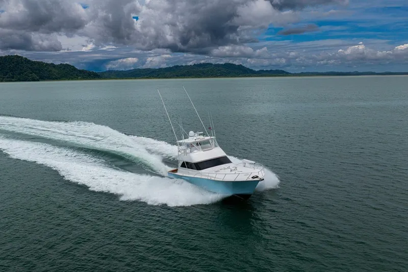 Mariah Jean Yacht Photos Pics 2004 Viking 61c yacht cruising on open water under cloudy skies.
