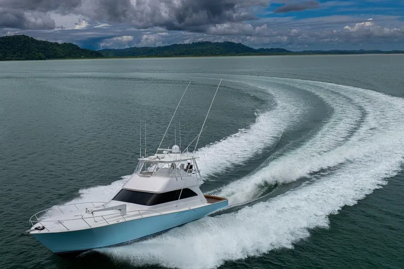 Mariah Jean Yacht Photos Pics 2004 Viking 61c yacht cruising on open water with scenic backdrop.