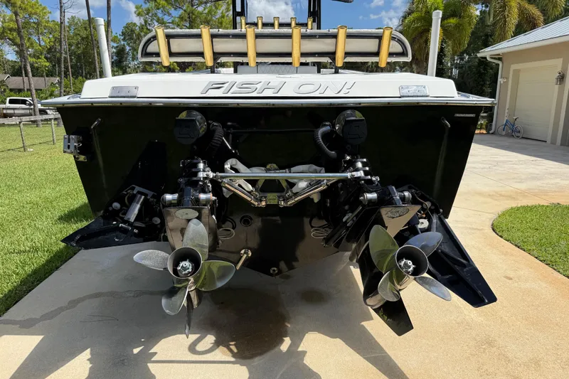  Yacht Photos Pics Rear view of a 2005 Apache 36CC boat with dual propellers on a sunny day.