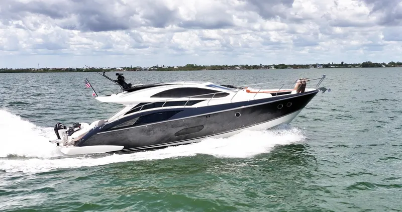 Inverse Entropy Yacht Photos Pics 2009 Marquis 500 Sport Coupe yacht cruising on open water under cloudy skies.