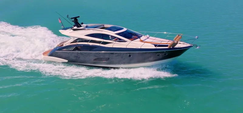 Inverse Entropy Yacht Photos Pics 2009 Marquis 500 Sport Coupe yacht cruising on turquoise waters.