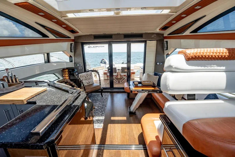 Inverse Entropy Yacht Photos Pics Luxurious interior of 2009 Marquis 500 Sport Coupe yacht with elegant seating and ocean view.