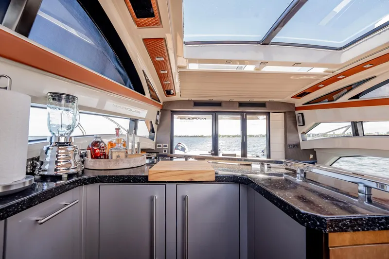 Inverse Entropy Yacht Photos Pics Luxurious interior of 2009 Marquis 500 Sport Coupe yacht with modern kitchen amenities.