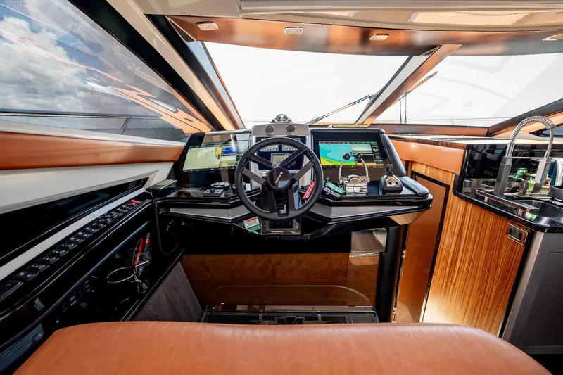 Inverse Entropy Yacht Photos Pics Interior cockpit of 2009 Marquis 500 Sport Coupe yacht with modern navigation equipment.