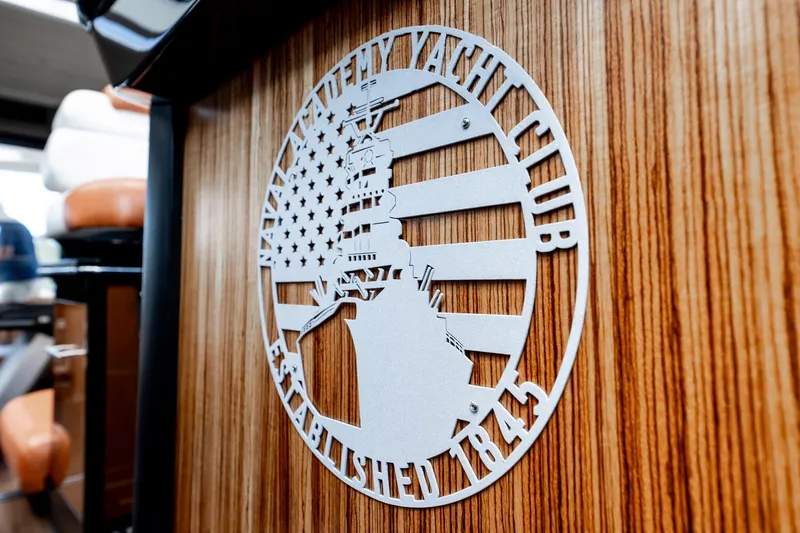 Inverse Entropy Yacht Photos Pics 2009 Marquis 500 Sport Coupe interior with yacht club emblem on wood paneling.