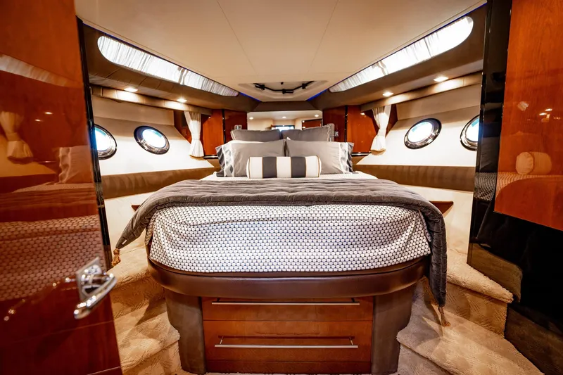 Inverse Entropy Yacht Photos Pics Luxurious bedroom interior of 2009 Marquis 500 Sport Coupe yacht with elegant bedding and porthole windows.