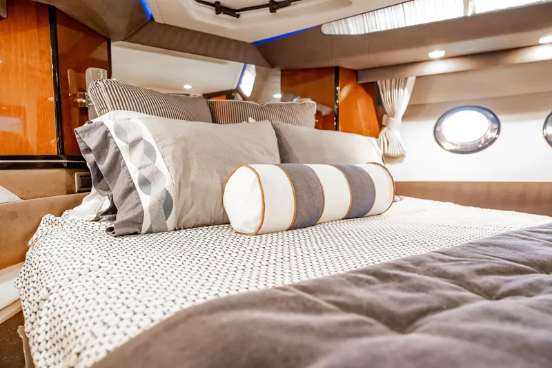 Inverse Entropy Yacht Photos Pics Luxurious interior of 2009 Marquis 500 Sport Coupe yacht bedroom with elegant bedding.