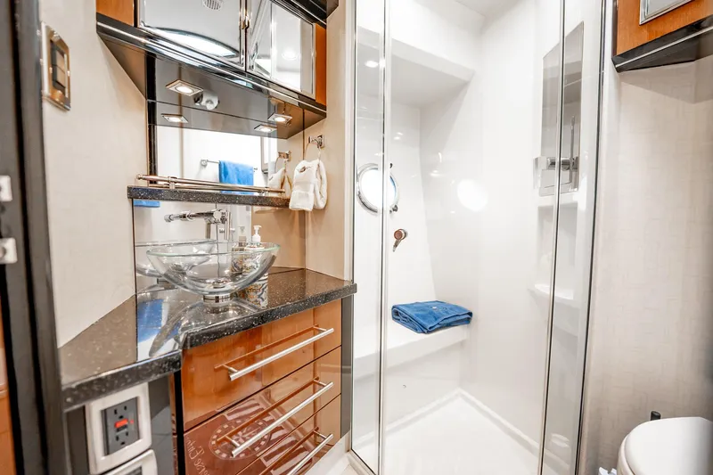 Inverse Entropy Yacht Photos Pics Luxurious bathroom in 2009 Marquis 500 Sport Coupe yacht with glass sink and modern shower.