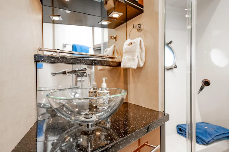 Inverse Entropy Yacht Photos Pics Luxurious bathroom in 2009 Marquis 500 Sport Coupe with glass sink and modern fixtures.