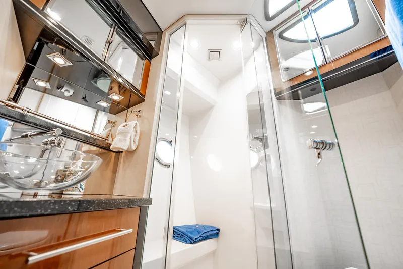 Inverse Entropy Yacht Photos Pics Luxurious bathroom in 2009 Marquis 500 Sport Coupe yacht with glass sink and modern shower.