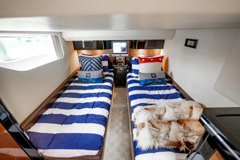 Inverse Entropy Yacht Photos Pics Luxurious 2009 Marquis 500 Sport Coupe cabin with twin beds and nautical decor.