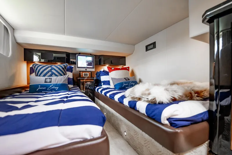 Inverse Entropy Yacht Photos Pics Luxurious 2009 Marquis 500 Sport Coupe cabin with striped bedding and cozy decor.