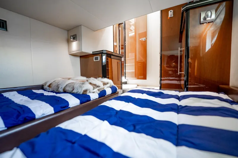 Inverse Entropy Yacht Photos Pics Interior of 2009 Marquis 500 Sport Coupe with striped bedding and modern wood finishes.