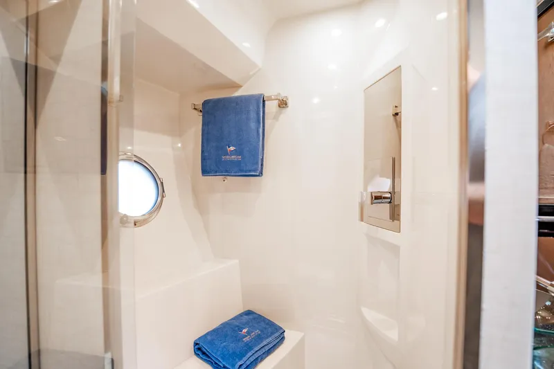 Inverse Entropy Yacht Photos Pics Luxurious bathroom in 2009 Marquis 500 Sport Coupe yacht with blue towels and porthole.