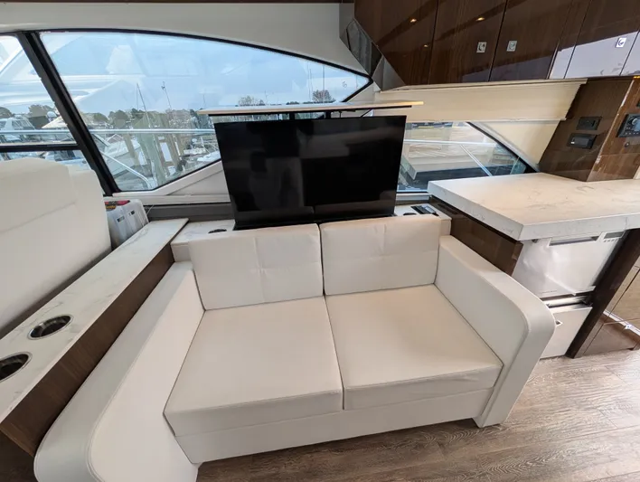 Emilia Yacht Photos Pics Interior of 2022 Cruisers Yachts 54 Cantius with sofa and TV.