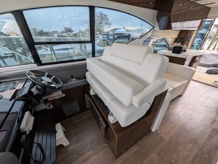 Emilia Yacht Photos Pics Interior of 2022 Cruisers Yachts 54 Cantius with helm and seating area.