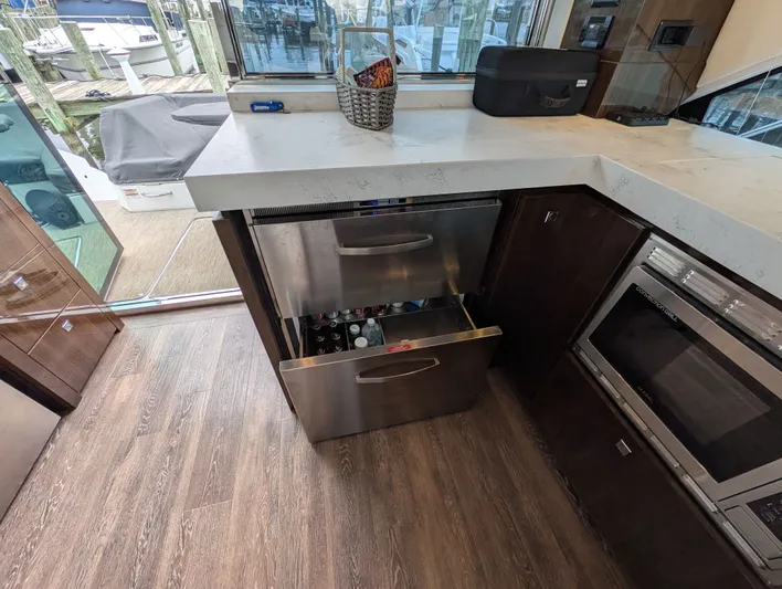 Emilia Yacht Photos Pics Interior of 2022 Cruisers Yachts 54 Cantius with open kitchen drawer.