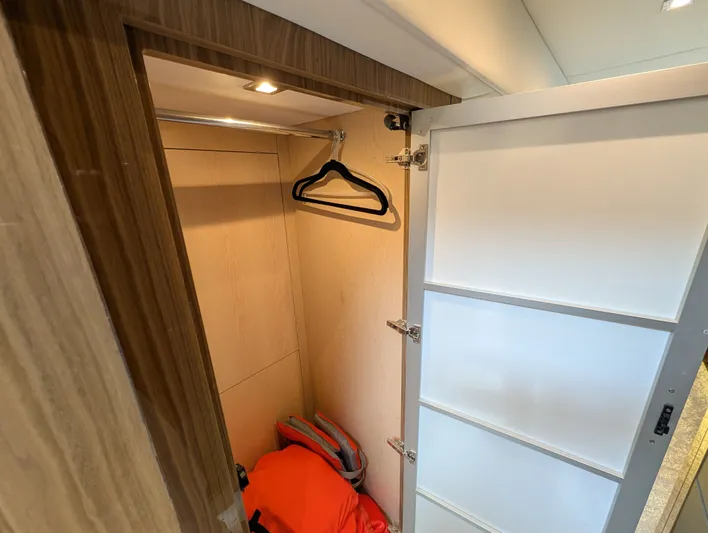 Emilia Yacht Photos Pics Interior of 2022 Cruisers Yachts 54 Cantius with closet and hangers.