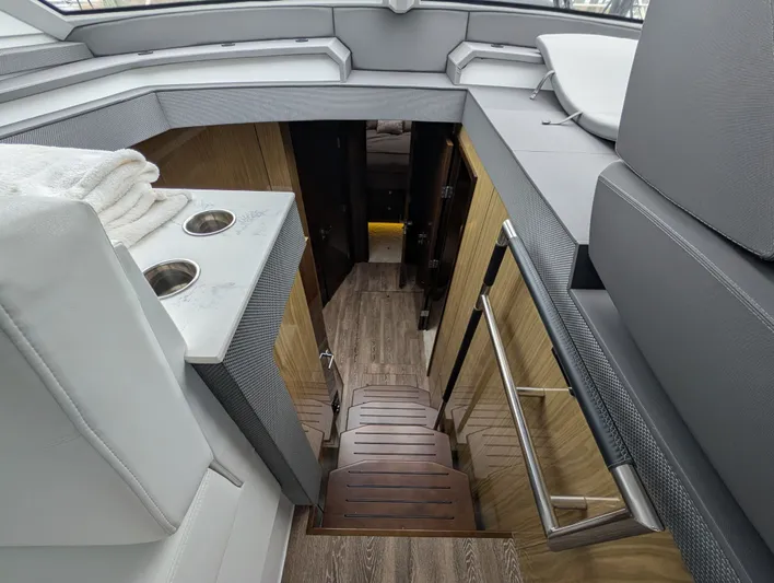 Emilia Yacht Photos Pics Interior of 2022 Cruisers Yachts 54 Cantius with stairs and wood paneling.