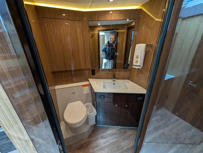 Emilia Yacht Photos Pics Luxurious bathroom of 2022 Cruisers Yachts 54 Cantius with wood paneling.