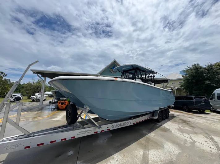  Yacht Photos Pics 2022 Invincible 33 Catamaran on trailer under cloudy sky.