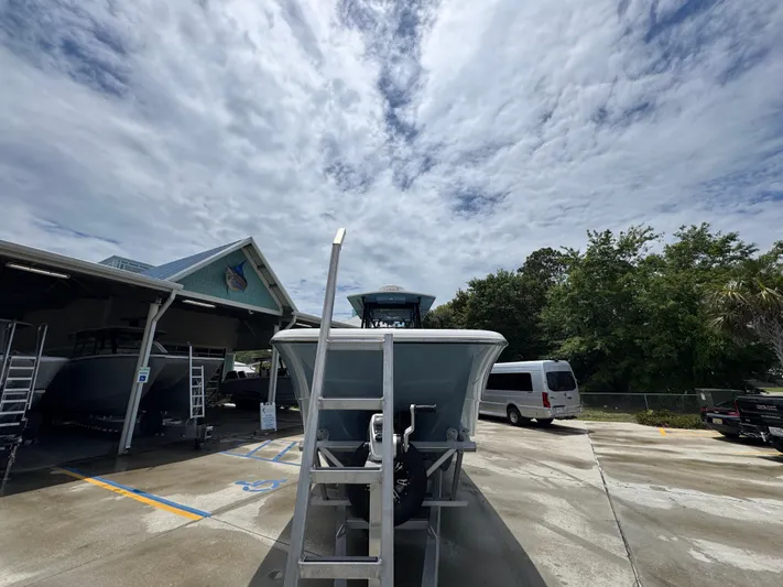  Yacht Photos Pics 2022 Invincible 33 Catamaran in a boatyard under a cloudy sky.