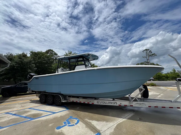  Yacht Photos Pics 2022 Invincible 33 Catamaran on trailer under cloudy sky.