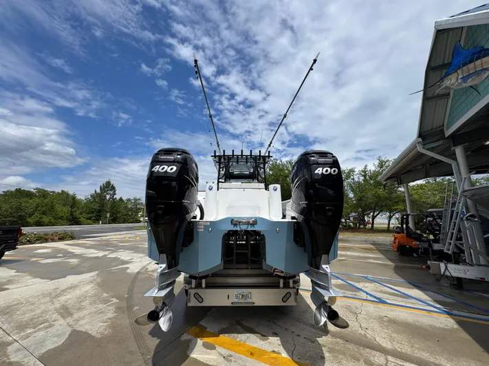  Yacht Photos Pics 2022 Invincible 33 Catamaran with twin 400 horsepower engines, parked outdoors under a cloudy sky.