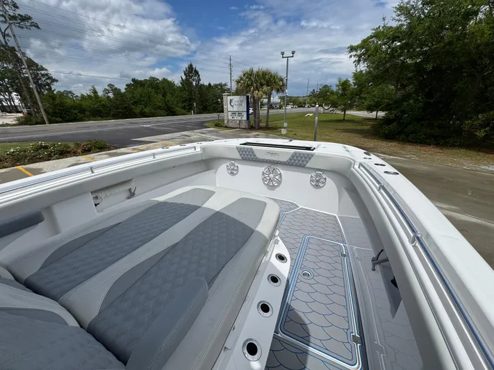  Yacht Photos Pics 2022 Invincible 33 Catamaran with spacious seating and modern design, docked outdoors.