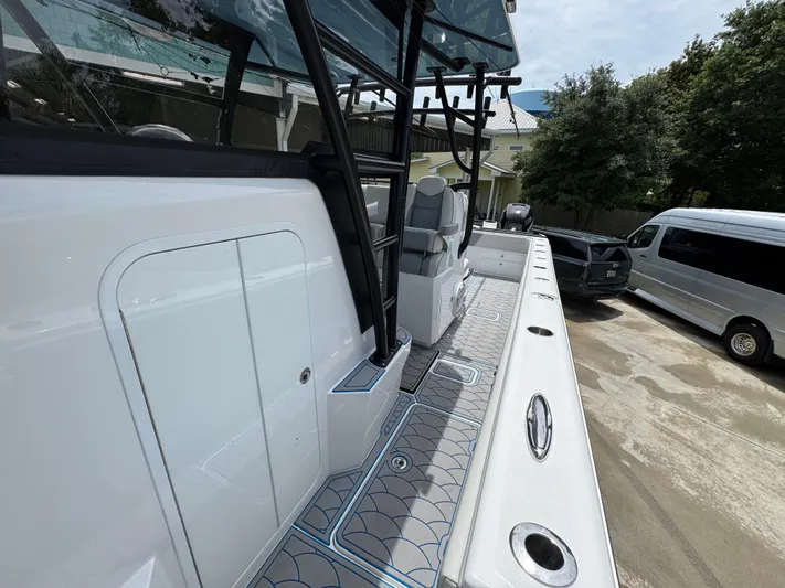  Yacht Photos Pics 2022 Invincible 33 Catamaran, sleek design, spacious deck, parked outdoors.