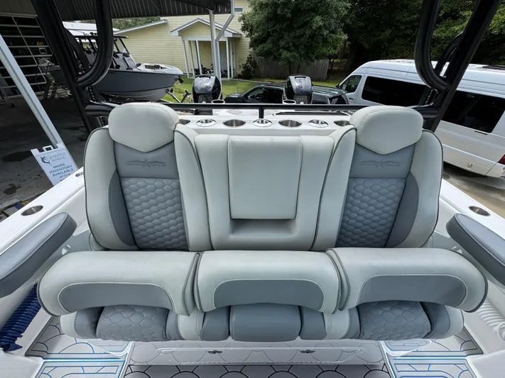  Yacht Photos Pics Luxurious seating on 2022 Invincible 33 Catamaran, featuring plush gray upholstery and modern design.