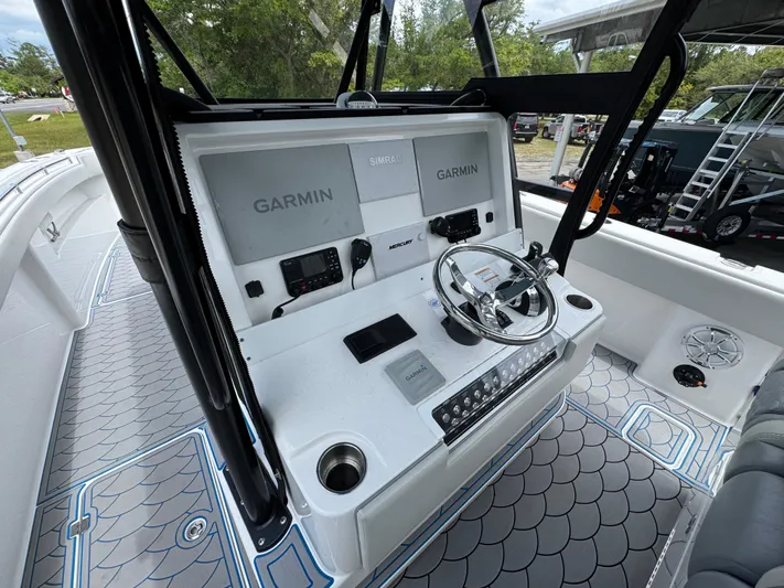  Yacht Photos Pics 2022 Invincible 33 Catamaran helm with Garmin displays and modern controls.