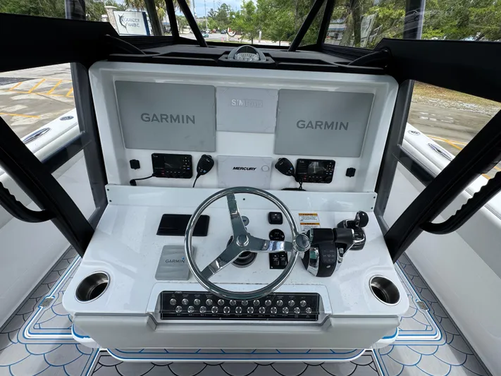  Yacht Photos Pics 2022 Invincible 33 Catamaran helm with dual Garmin displays and Mercury controls.