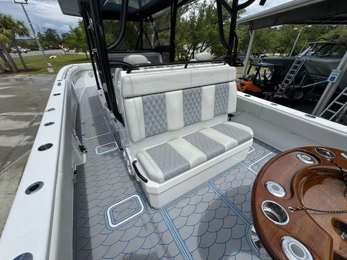  Yacht Photos Pics 2022 Invincible 33 Catamaran interior with cushioned seating and stylish deck design.