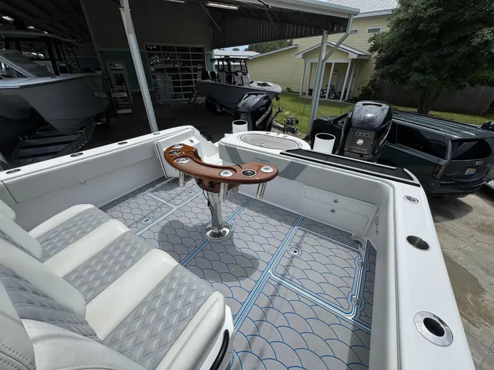  Yacht Photos Pics 2022 Invincible 33 Catamaran interior with seating, fishing rod holders, and modern flooring.