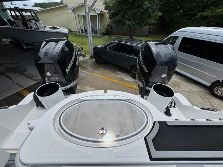  Yacht Photos Pics 2022 Invincible 33 Catamaran with dual outboard engines, parked near vehicles.