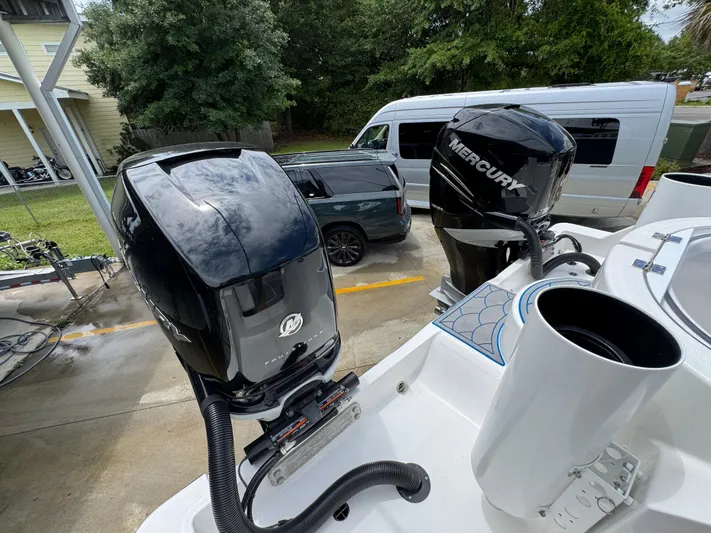  Yacht Photos Pics 2022 Invincible 33 Catamaran with dual Mercury outboard engines in a driveway setting.