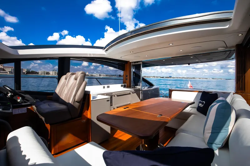 Mermoo Too Yacht Photos Pics Luxurious 2024 Princess V55 yacht interior with elegant seating and ocean view.