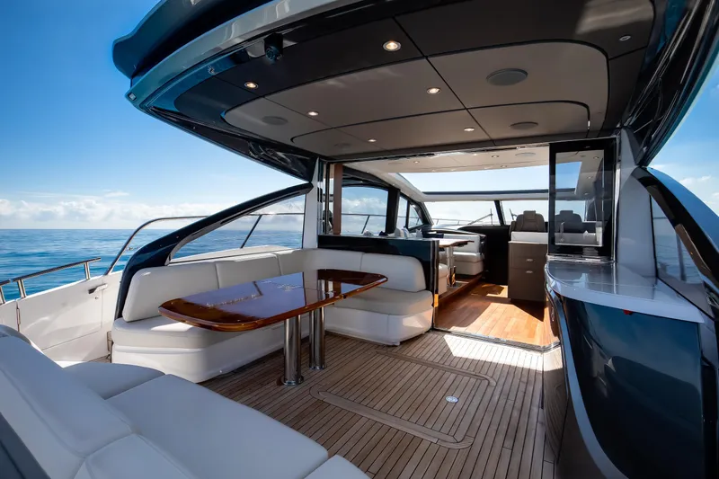 Mermoo Too Yacht Photos Pics Luxurious 2024 Princess V55 yacht interior with elegant seating and ocean view.