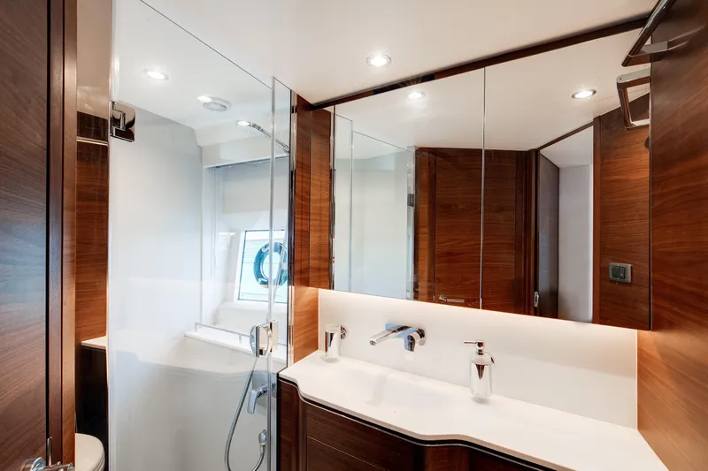 Mermoo Too Yacht Photos Pics Luxurious bathroom in 2024 Princess V55 yacht, featuring sleek design and modern fixtures.