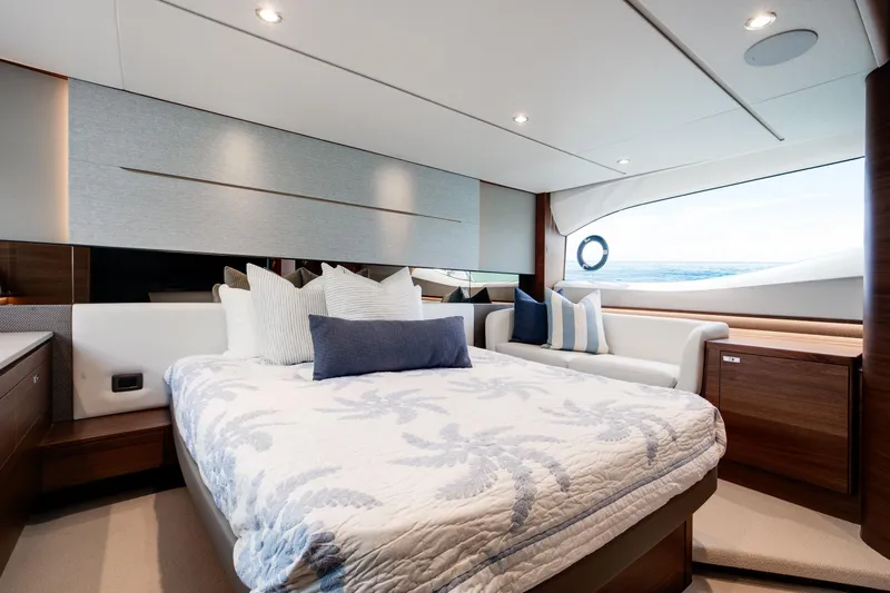 Mermoo Too Yacht Photos Pics Luxurious 2024 Princess V55 yacht bedroom with elegant bedding and ocean view.