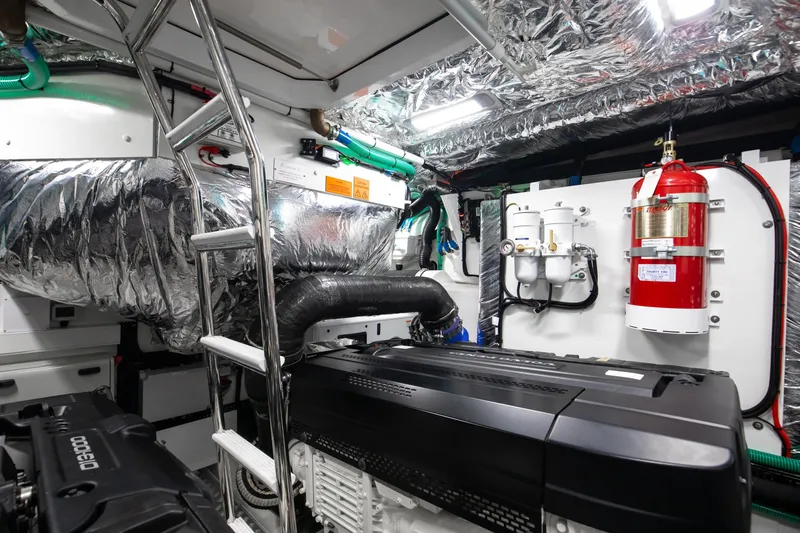 Mermoo Too Yacht Photos Pics Engine room of 2024 Princess V55 yacht with fire extinguisher and metallic insulation.