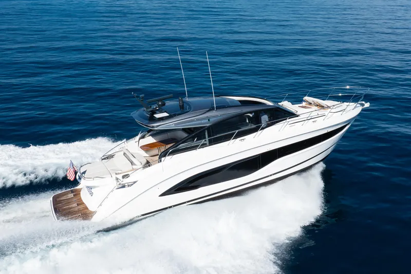 Mermoo Too Yacht Photos Pics 2024 Princess V55 yacht cruising on open sea, showcasing sleek design and luxury features.